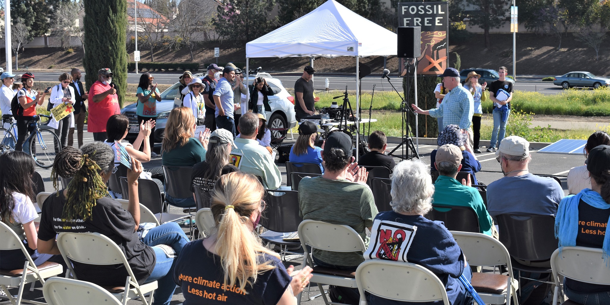 Speaker and audience at fossil-free outdoor event