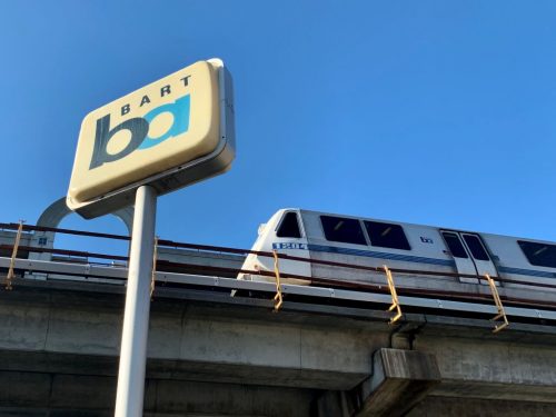 BART Train on elevated track near BART sign