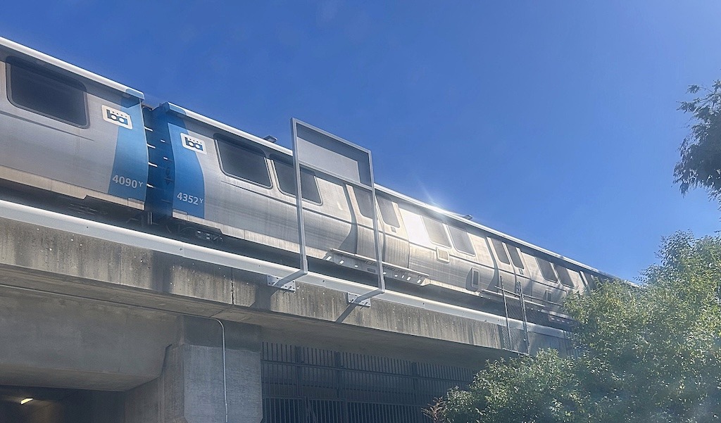 Silver metro train on an elevated track against a clear blue sky. Measure RTM Bay Area Transit Tax | 2026 CA Ballot Measure RTM Bay Area Transit Tax | 2026 CA Ballot